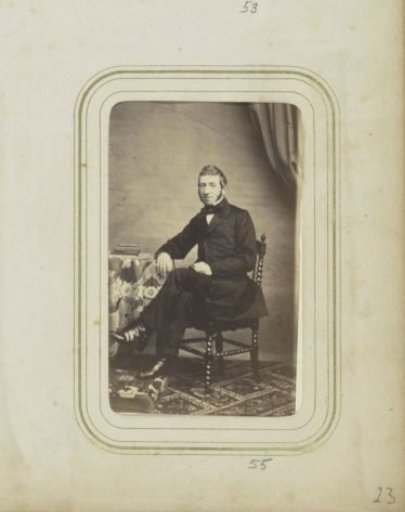 Portrait of a man with sideburns in a long coat