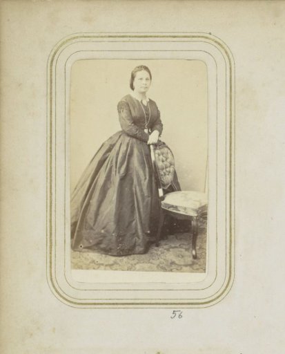 Portrait of a woman with a necklace in a long dress