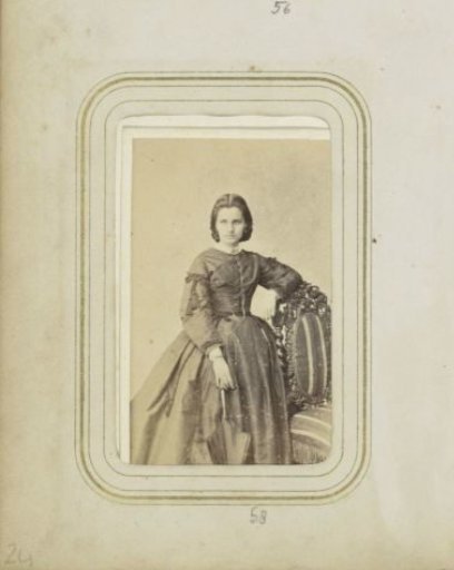 Portrait of a woman with an umbrella in a long dress