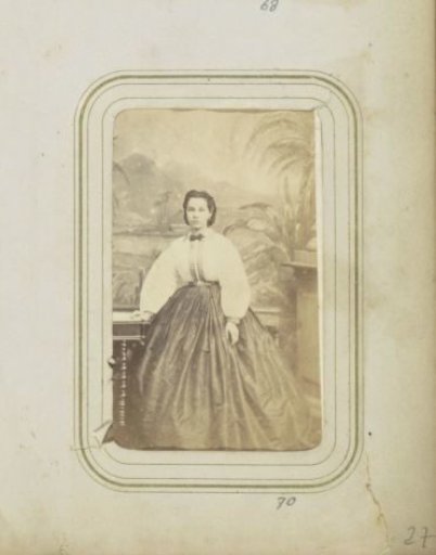 Portrait of a Woman in a Wide Skirt and a White Blouse with a Bow