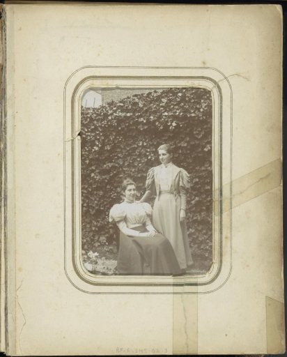 Two women posing in a garden