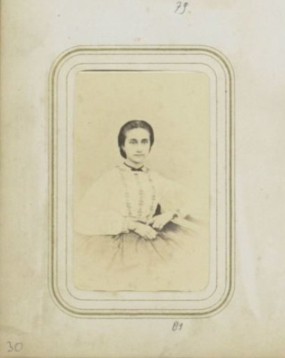 Portrait of a woman in a white blouse with her hair up