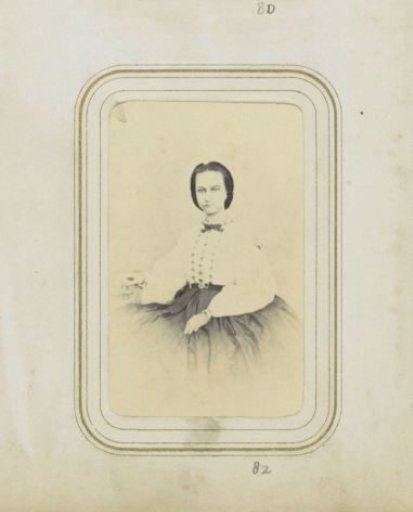 Portrait of a woman in a white blouse with her hair up