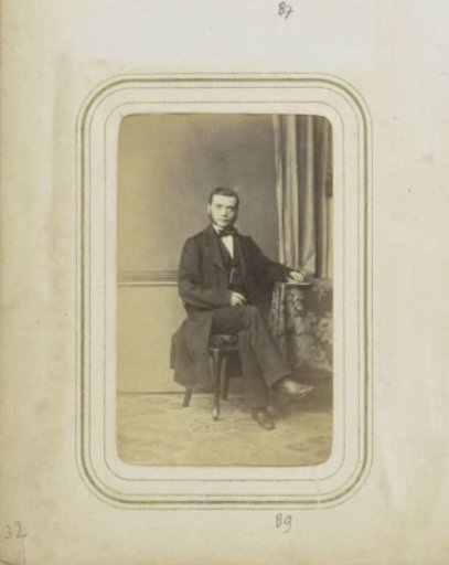 Portrait of a man in a long coat with sideburns