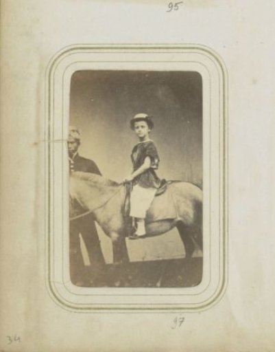 Portrait of a Dutch child on a pony with an Indonesian man