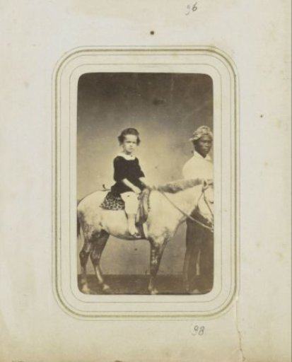 Portrait of a Dutch child on a pony with an Indonesian man