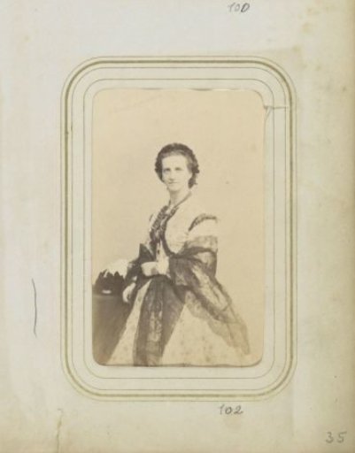 Portrait of a woman in a dress with a necklace and a bracelet