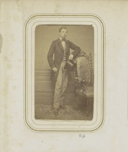 Portrait of F.H.P. Ligtenberg in a long coat with a hat and a walking stick