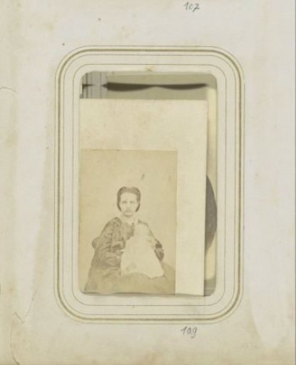 Portrait of a woman in a dress with a baby on her lap