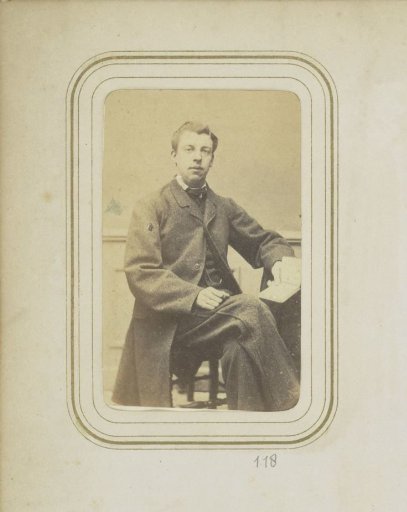 Portrait of F.H.P. Ligtenberg in a long coat with an open book in his hand