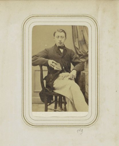 Portrait of a man in a coat with a book in his hand
