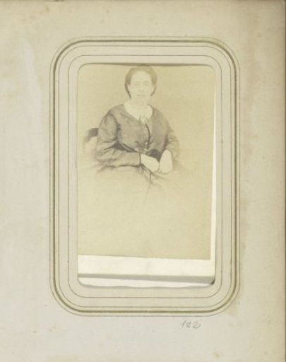 Portrait of a woman in a dress with a brooch