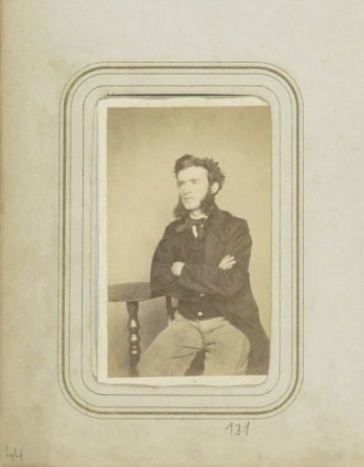 Portrait of a man in a long coat with sideburns