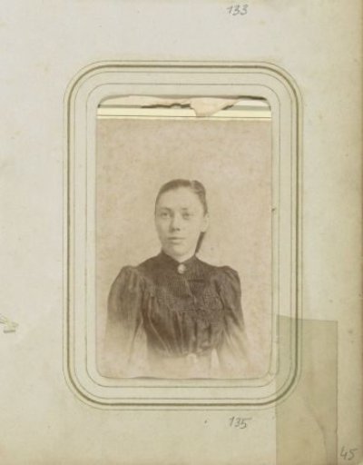 Portrait of a woman in a dress with a necklace