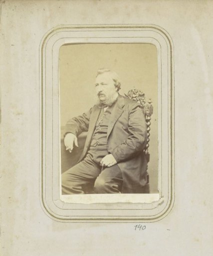 Portrait of a man smoking a cigar with sideburns