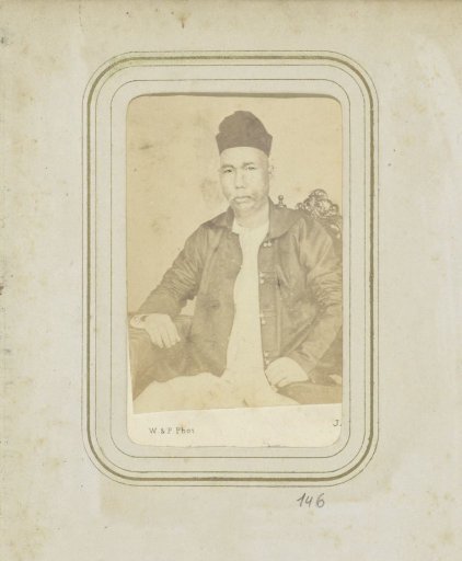 Portrait of a man in a coat with a head covering