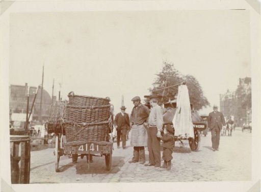 Workers with a cart of wicker baskets on the Prins Hendrikkade