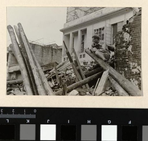 John Fernhout with a camera on a collapsed building, China