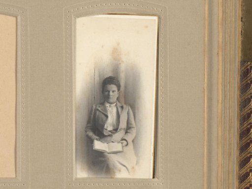 Studio portrait of Margo J.J. Kessler-de Lange with a book on her lap