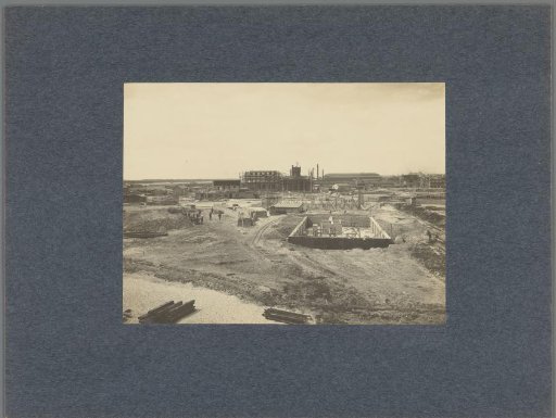 Construction sites in the polder of Nieuw-Mathenesse with the water tower of Schiedam in the background