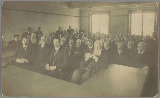 Group portrait of about 70 gentlemen in a hall