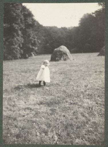 Girl walking in mown grass