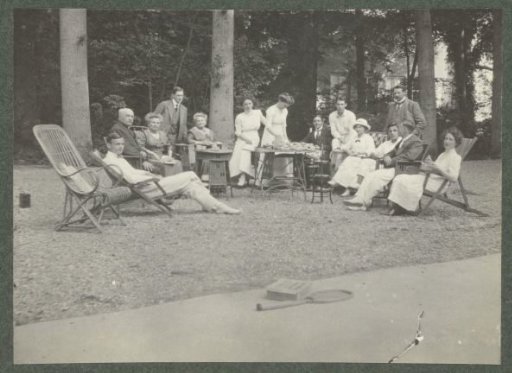 Group portrait of the Kessler family at an outdoor table having a cup of coffee