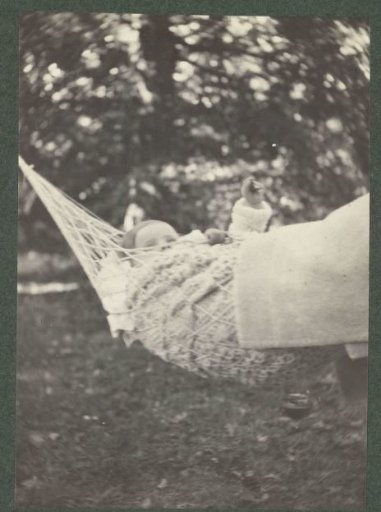 Baby in a hammock wrapped in a blanket