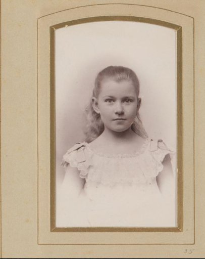 Studio portrait of An Kessler in his youth wearing a white dress