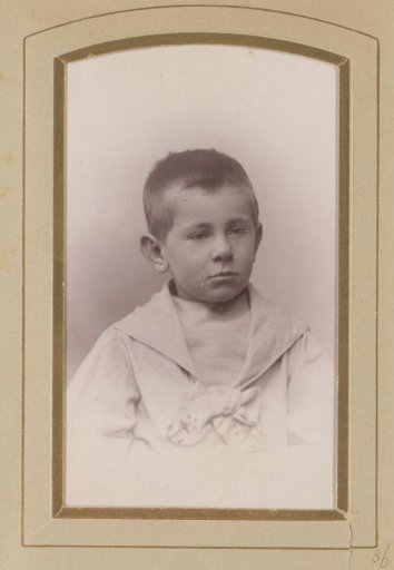 Studio portrait of Guus Kessler in his youth wearing a white sailor's suit