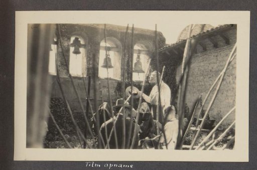 Three people in the courtyard of Mission San Juan Capistrano