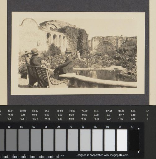 Four people in the courtyard of Mission San Juan Capistrano