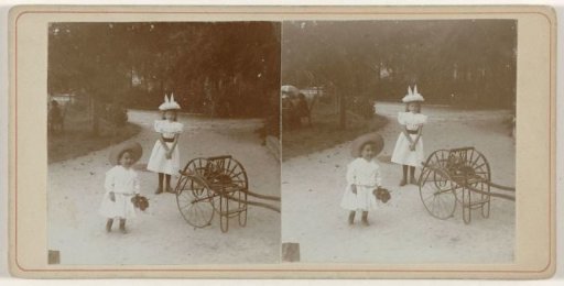 Two Children by a Small Carriage on a Gravel Path