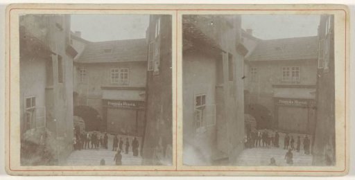 Group of People Standing in a Street Before a School