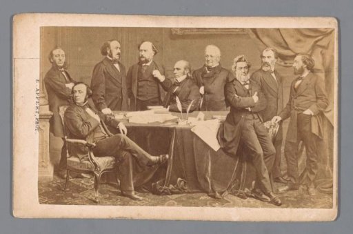 Photomontage of nine men (politicians) around a table, including Louis Adolphe Thiers (fourth from right) and Jules Favre (third from right)