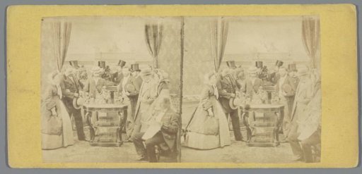 Group of men and women around a table with a sculpture, at an exhibition