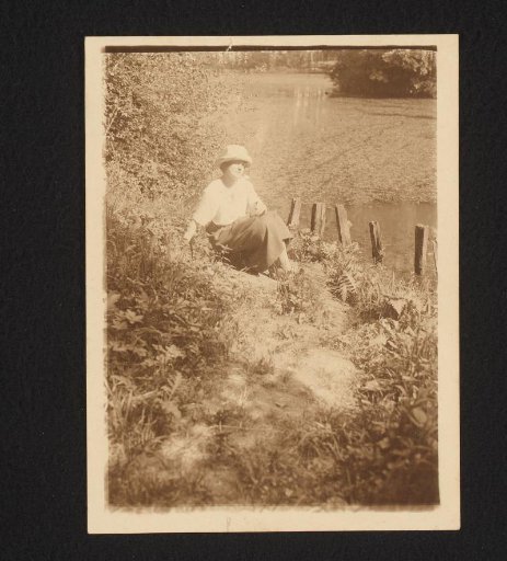 Woman sitting on a bank