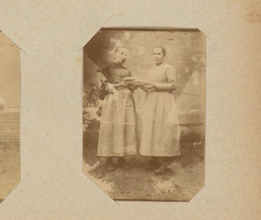 Portrait of two standing women with a plate