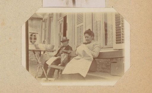 Portrait of a man with a newspaper and a woman with needlework