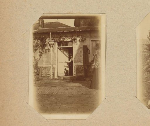 Woman with a dog in a doorway, another woman watching