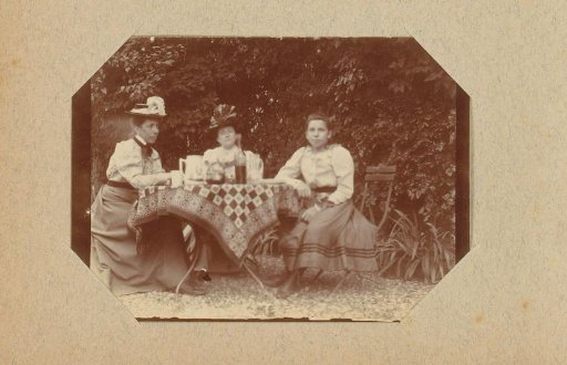 Three women at a table in a garden