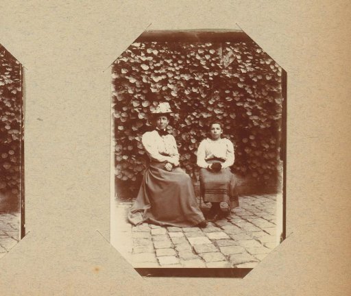 Portrait of two women by a wall with ivy