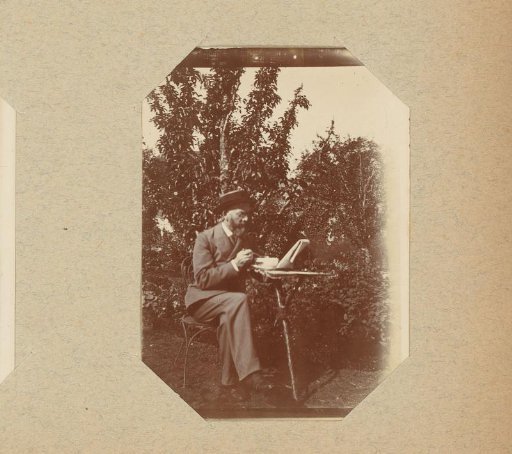 Man with a newspaper in a garden