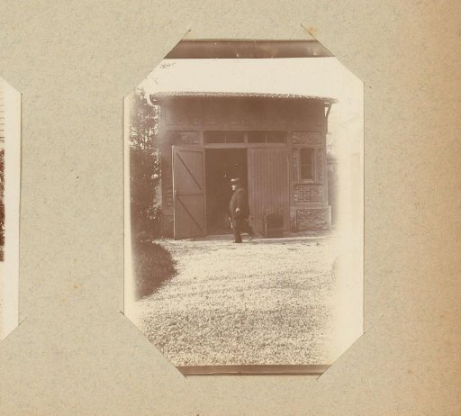 Man walking in front of a stable or garage