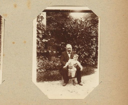 Portrait of an old man and a boy in a garden