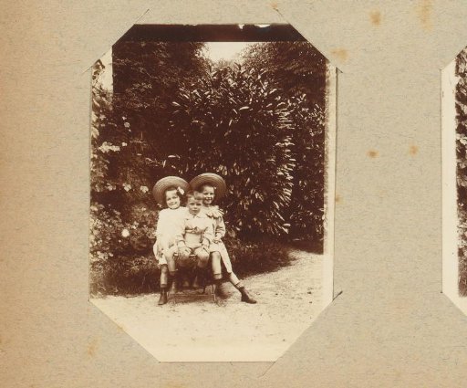 Portrait of two girls and a boy in a garden