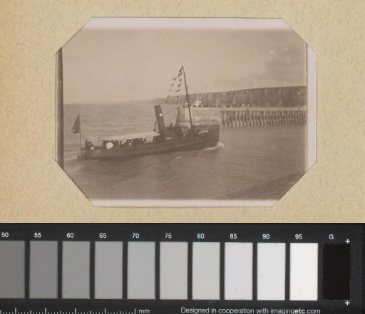 Steamship heading towards a pier