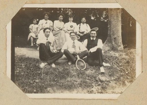 Group portrait of three women, four men and a girl with tennis rackets