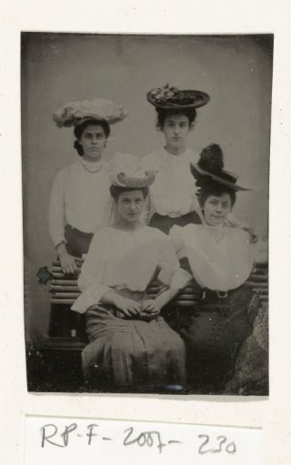 Portrait of four young women with hats