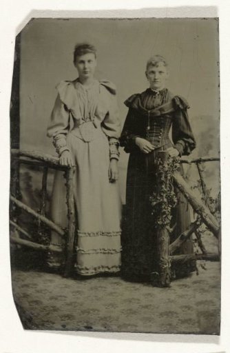 Portrait of Two Women Standing in a Studio